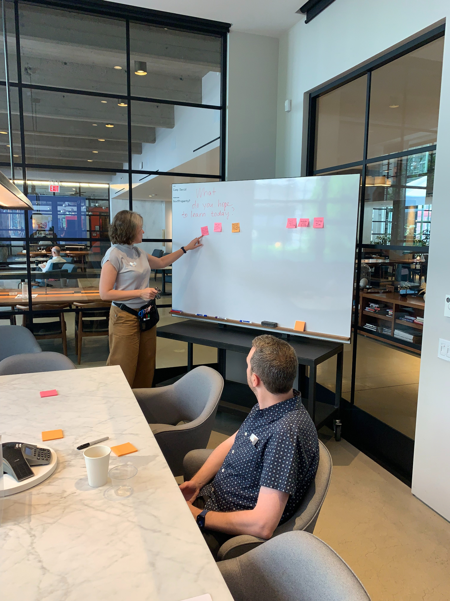 Marina facilitating a workshop at a whiteboard